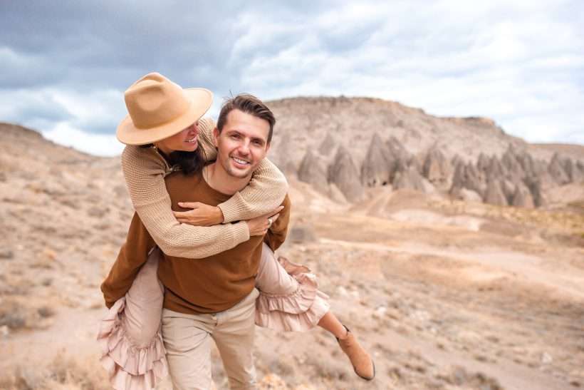 Happy couple on summer vacation in famous place. Cave formations.